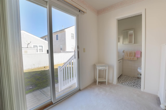 doorway to outside with light colored carpet