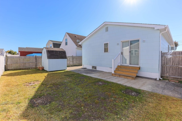 rear view of property featuring a yard and a shed