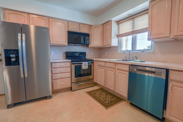 kitchen with sink, stainless steel appliances, and light brown cabinetry