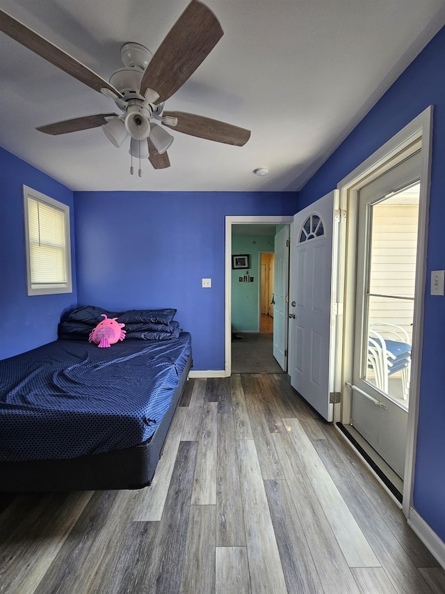 bedroom featuring baseboards, a ceiling fan, and wood finished floors