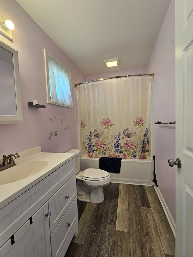 bathroom with vanity, shower / bath combo with shower curtain, toilet, and wood finished floors