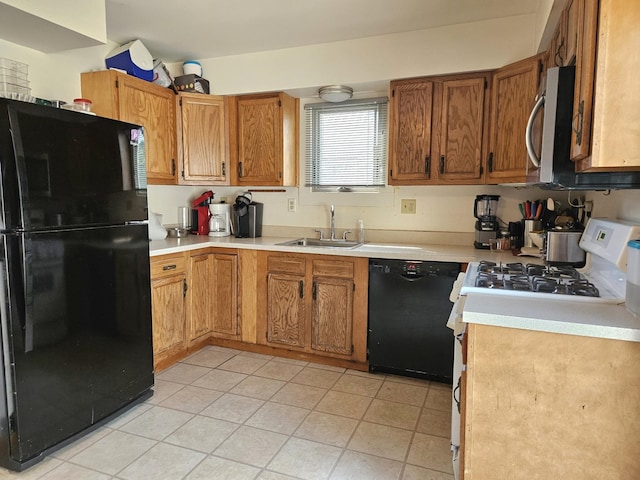 kitchen featuring light countertops, brown cabinetry, a sink, and black appliances