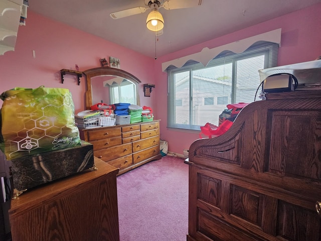 bedroom with light colored carpet and a ceiling fan