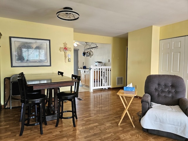 dining space featuring visible vents and wood finished floors