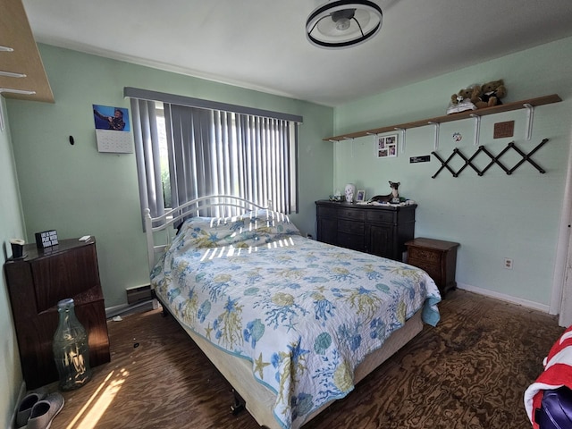 bedroom featuring baseboards and wood finished floors