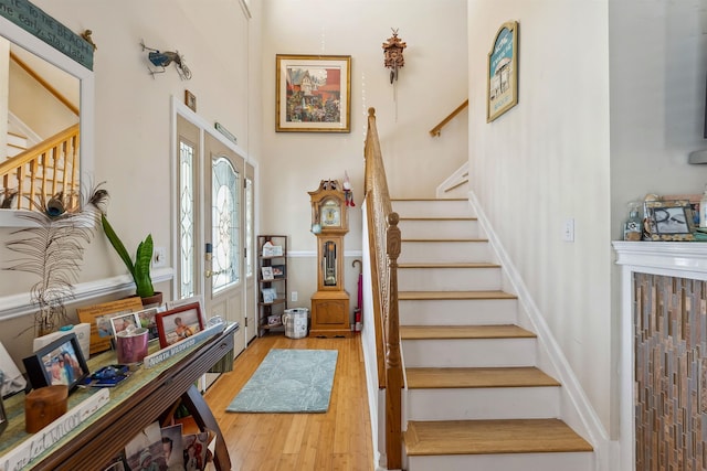 foyer entrance with stairway and wood finished floors