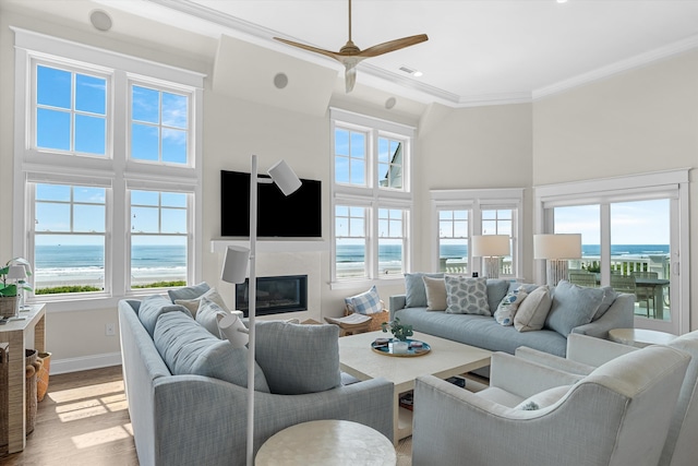 1 108th St, Stone Harbor, NJ 08247 - living room featuring ornamental molding, light wood-type flooring, a high end fireplace, a high ceiling, and a ceiling fan