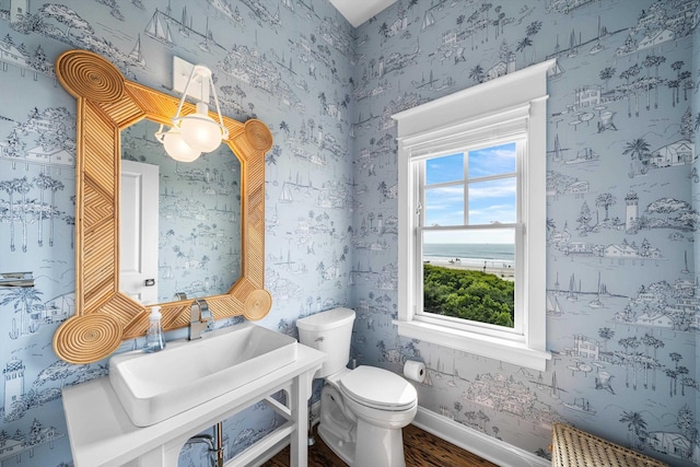 1 108th St, Stone Harbor, NJ 08247 - half bathroom with wallpapered walls and wood finished floors