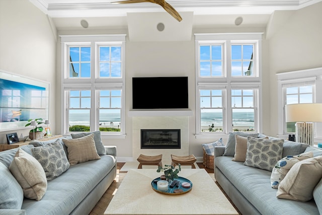 1 108th St, Stone Harbor, NJ 08247 - living room with a premium fireplace, dark wood-style floors, crown molding, and a towering ceiling