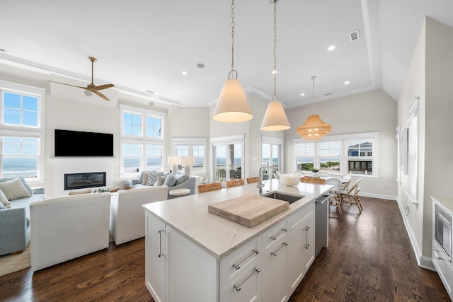 1 108th St, Stone Harbor, NJ 08247 - kitchen with a glass covered fireplace, ceiling fan, dark wood-type flooring, a kitchen island with sink, and hanging light fixtures