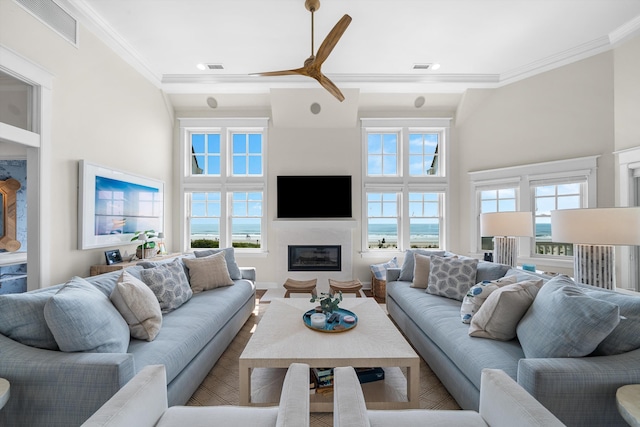 1 108th St, Stone Harbor, NJ 08247 - living area featuring crown molding, ceiling fan, a glass covered fireplace, and a towering ceiling