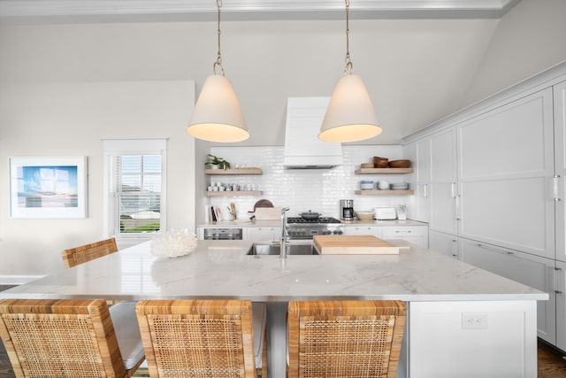 1 108th St, Stone Harbor, NJ 08247 - kitchen featuring open shelves, custom range hood, lofted ceiling, white cabinets, and a kitchen island with sink