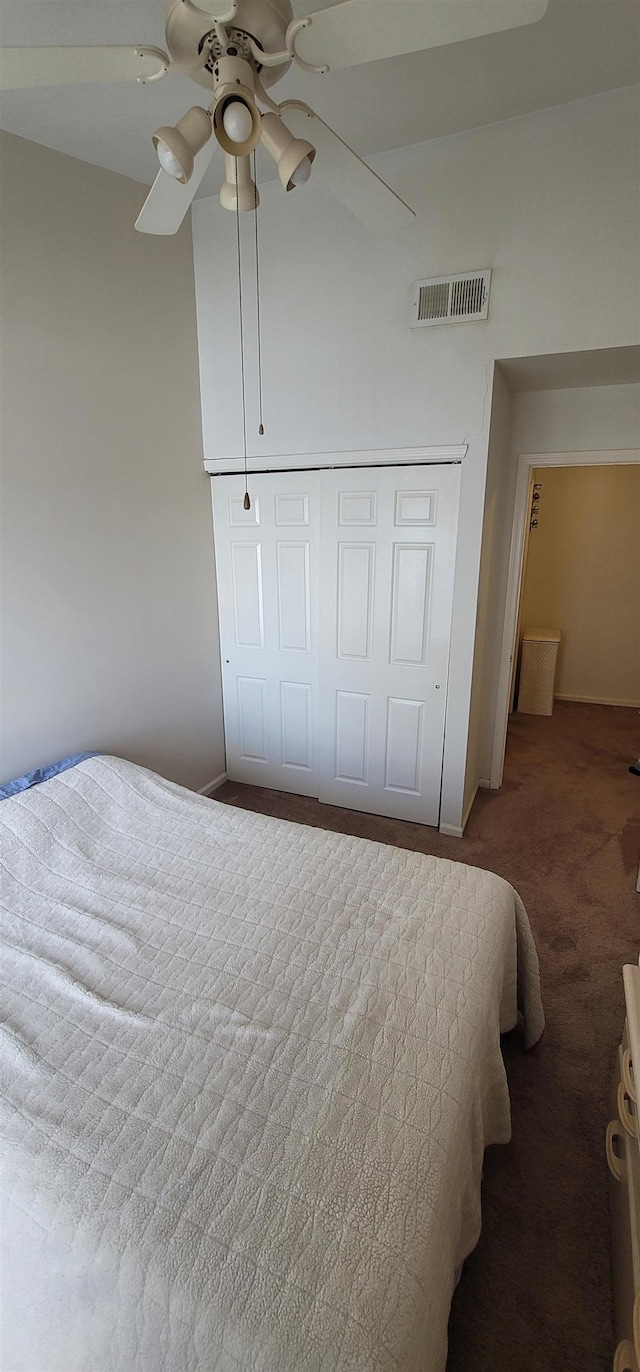 bedroom with carpet flooring, ceiling fan, and a closet