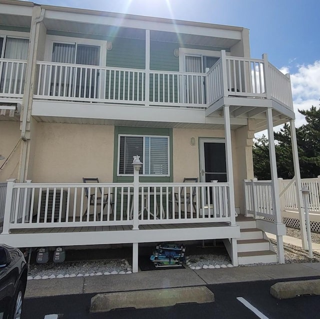 back of house with a balcony