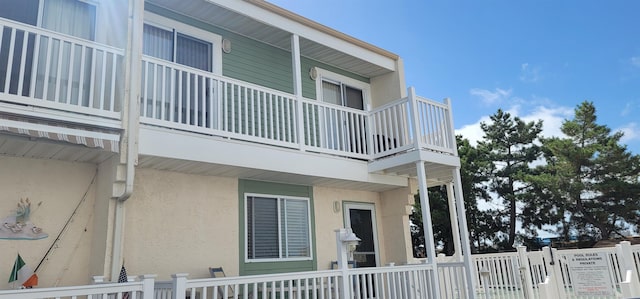 view of side of property with a balcony