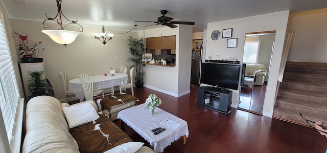 living room featuring ceiling fan with notable chandelier and dark wood-type flooring