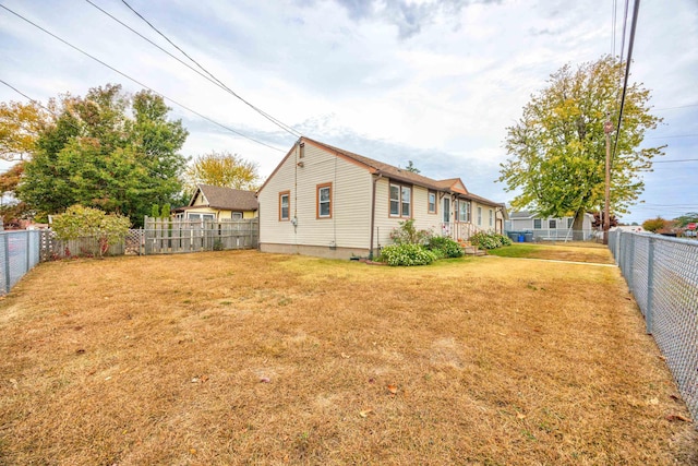 back of property featuring a yard