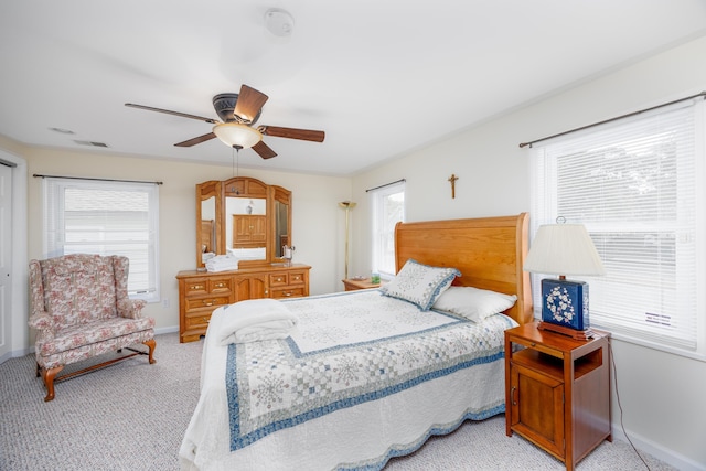 bedroom featuring ceiling fan and light carpet