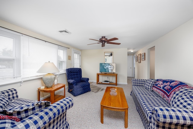 carpeted living room featuring ceiling fan