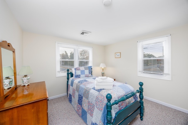 bedroom featuring light carpet