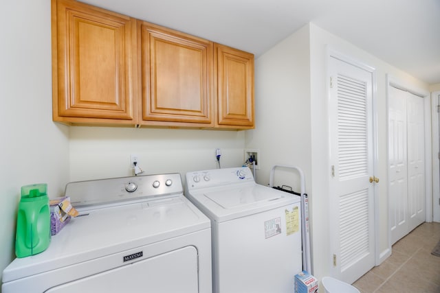 laundry area with light tile patterned floors, cabinets, and independent washer and dryer