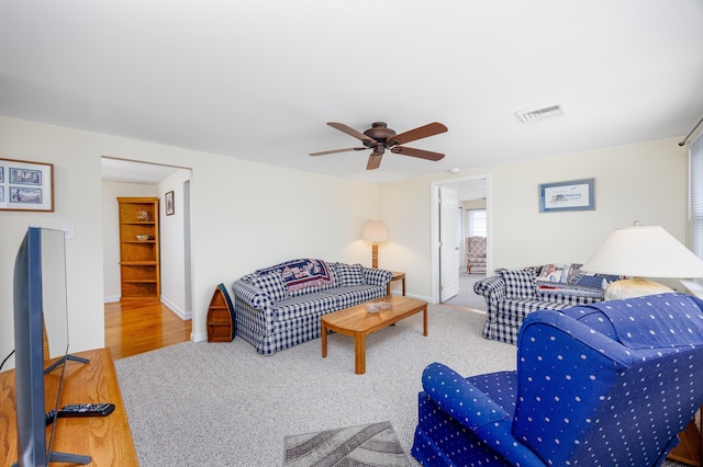 living room with ceiling fan and carpet floors