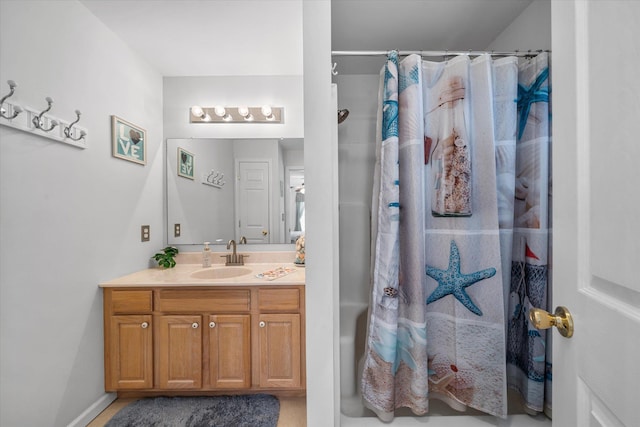 bathroom with curtained shower and vanity