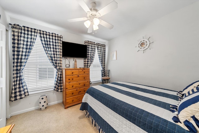 bedroom with a ceiling fan, carpet, and baseboards