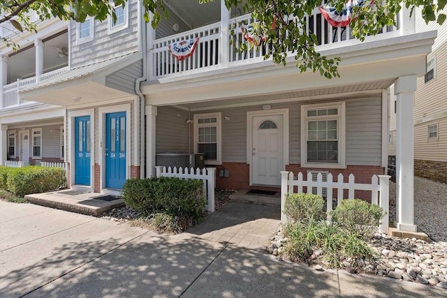 doorway to property with brick siding and a porch