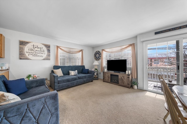 living area featuring light carpet