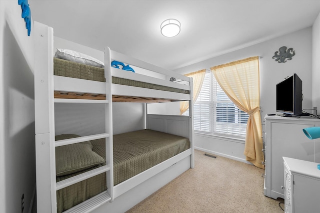 bedroom with baseboards and visible vents