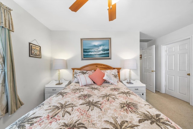 bedroom with a ceiling fan and light colored carpet