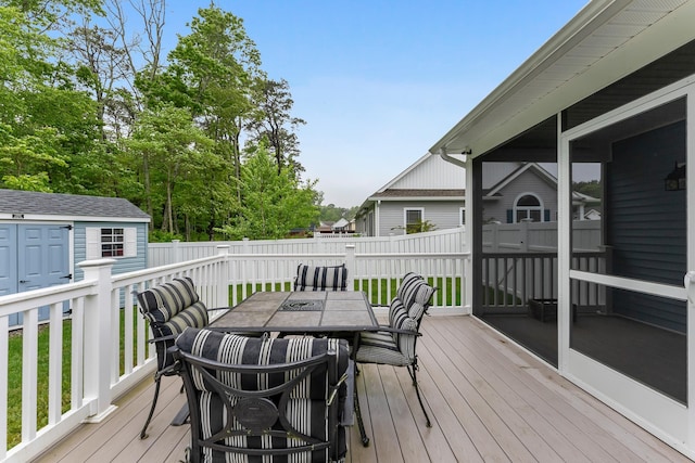 19 Canterbury Way, Cape May Court House, NJ 08210 - deck with outdoor dining space, a fenced backyard, a storage unit, and an outbuilding