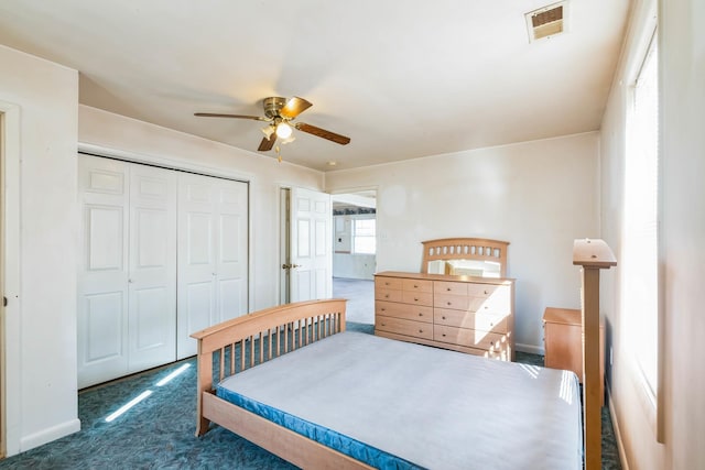 bedroom with ceiling fan, a closet, and dark colored carpet