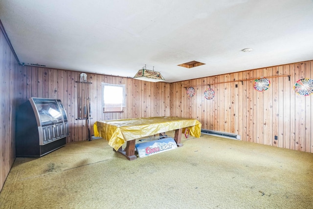 unfurnished bedroom featuring a baseboard radiator, carpet, and wood walls