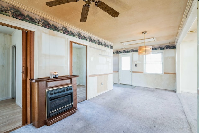 living room featuring ornamental molding, carpet, a textured ceiling, and a fireplace