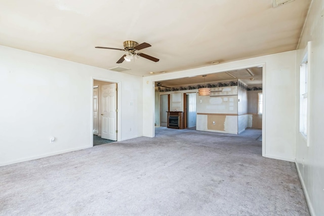 unfurnished living room featuring carpet floors and ceiling fan