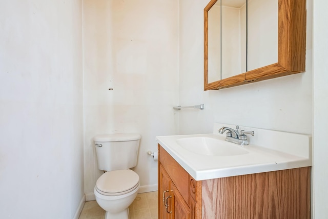 bathroom with vanity, toilet, and tile patterned flooring