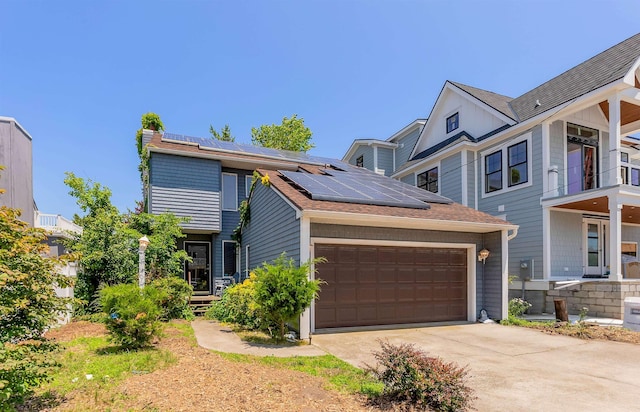 129 W Hollywood Ave, Wildwood Crest, NJ 08260 - view of front of house with solar panels, an attached garage, driveway, and roof with shingles