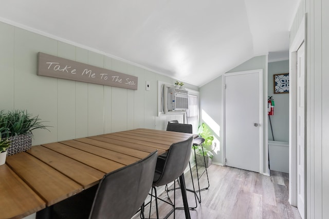 dining area featuring lofted ceiling and light hardwood / wood-style floors