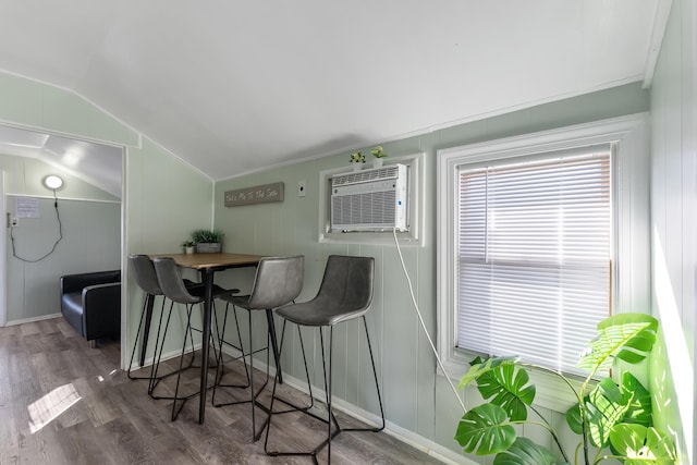 interior space with lofted ceiling, a wall mounted air conditioner, and dark wood-type flooring