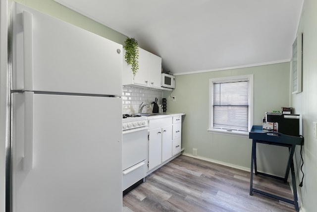 kitchen with sink, backsplash, white cabinets, white appliances, and light wood-type flooring