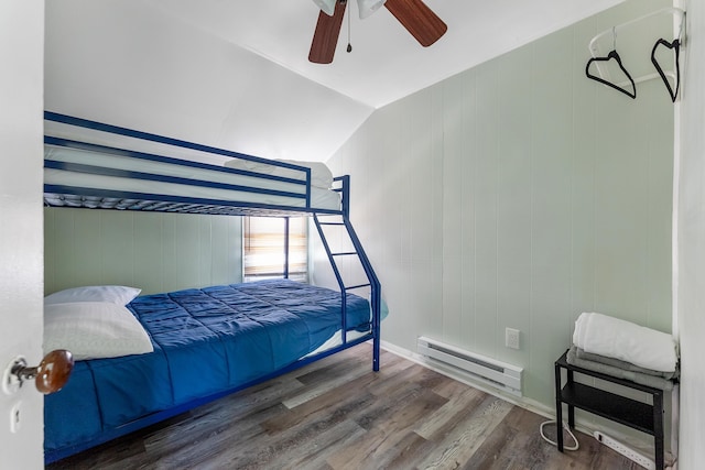 bedroom featuring lofted ceiling, hardwood / wood-style flooring, a baseboard radiator, and ceiling fan