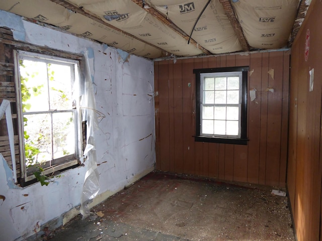 unfurnished room with wooden walls