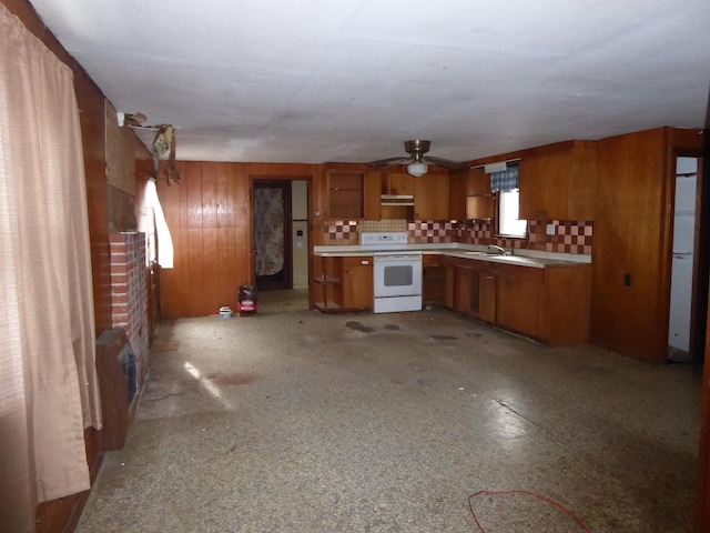 kitchen with ceiling fan, decorative backsplash, electric range, and sink