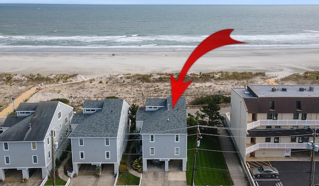 aerial view featuring a view of the beach and a water view