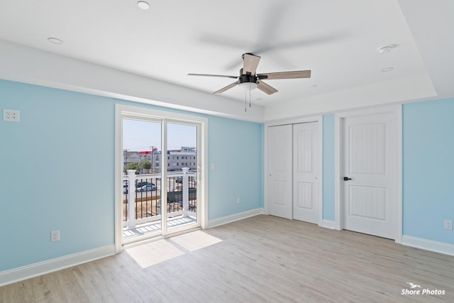 unfurnished bedroom with access to outside, ceiling fan, and light hardwood / wood-style floors