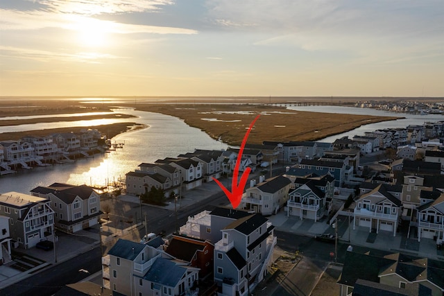 bird's eye view featuring a water view and a residential view