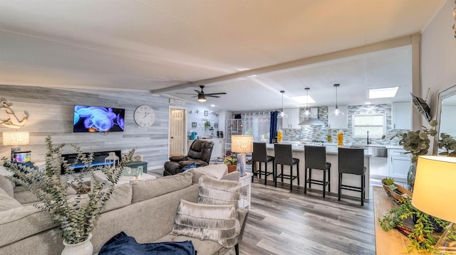 38 Kings Ln, Cape May Court House, NJ 08210 - living area with light wood-style floors, wooden walls, and ceiling fan