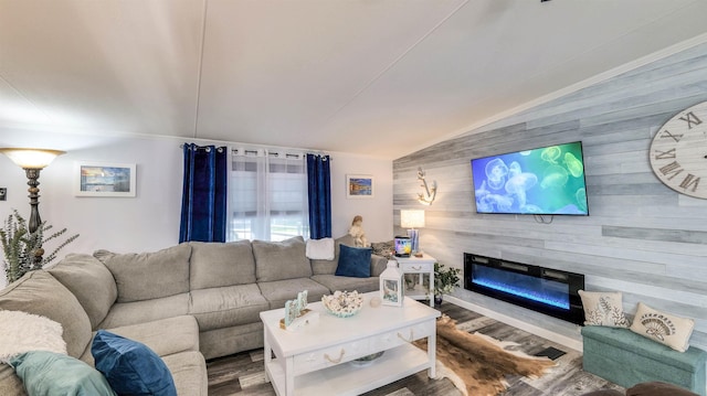 38 Kings Ln, Cape May Court House, NJ 08210 - living area featuring lofted ceiling, wooden walls, a glass covered fireplace, an accent wall, and wood finished floors